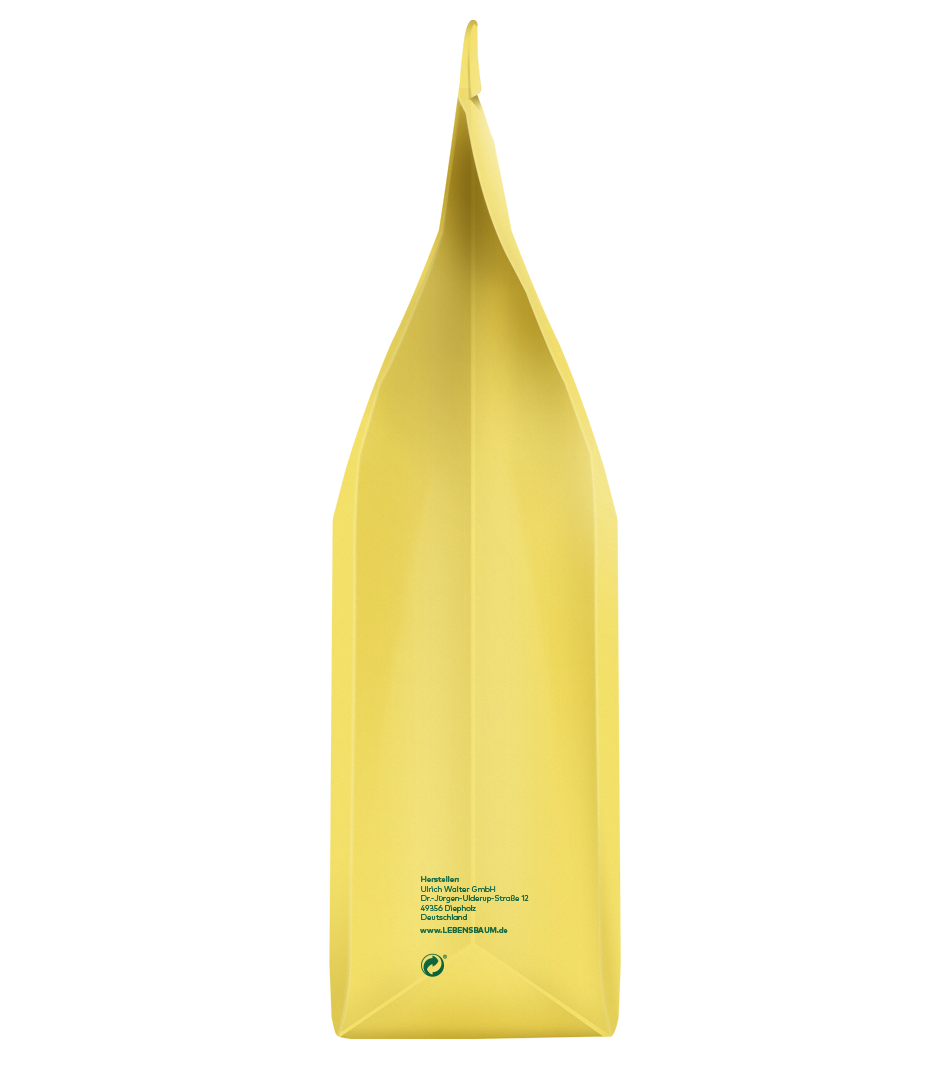 Gelbe Verpackung mit spitzer Form, Herstellerangaben und grünem Logo auf der Rückseite sichtbar.