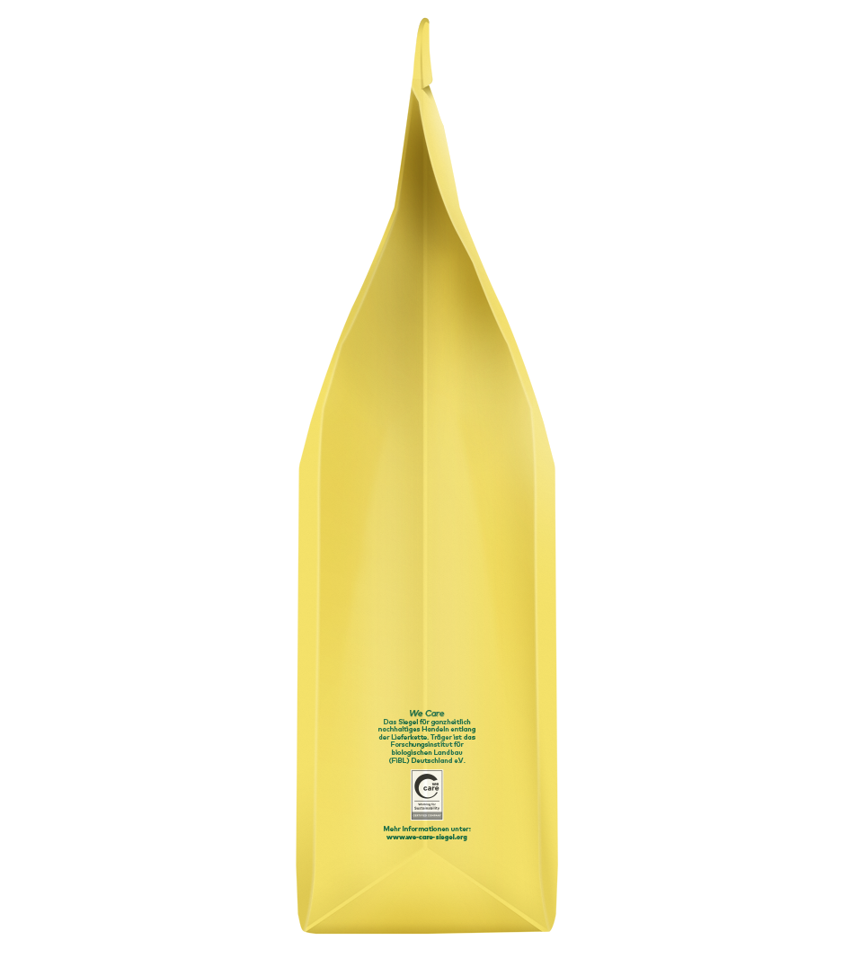 Gelbe Verpackung mit spitzer Oberseite, fairtrade-zertifiziert, Rückseite mit Produktinformationen und Care-Logo sichtbar
